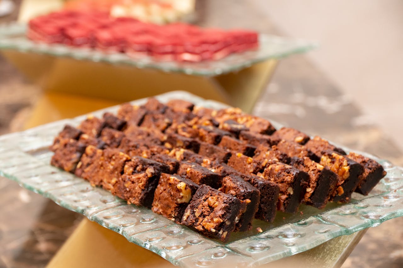 heros-img Close-up of delicious chocolate brownies with nuts, perfect for dessert lovers.